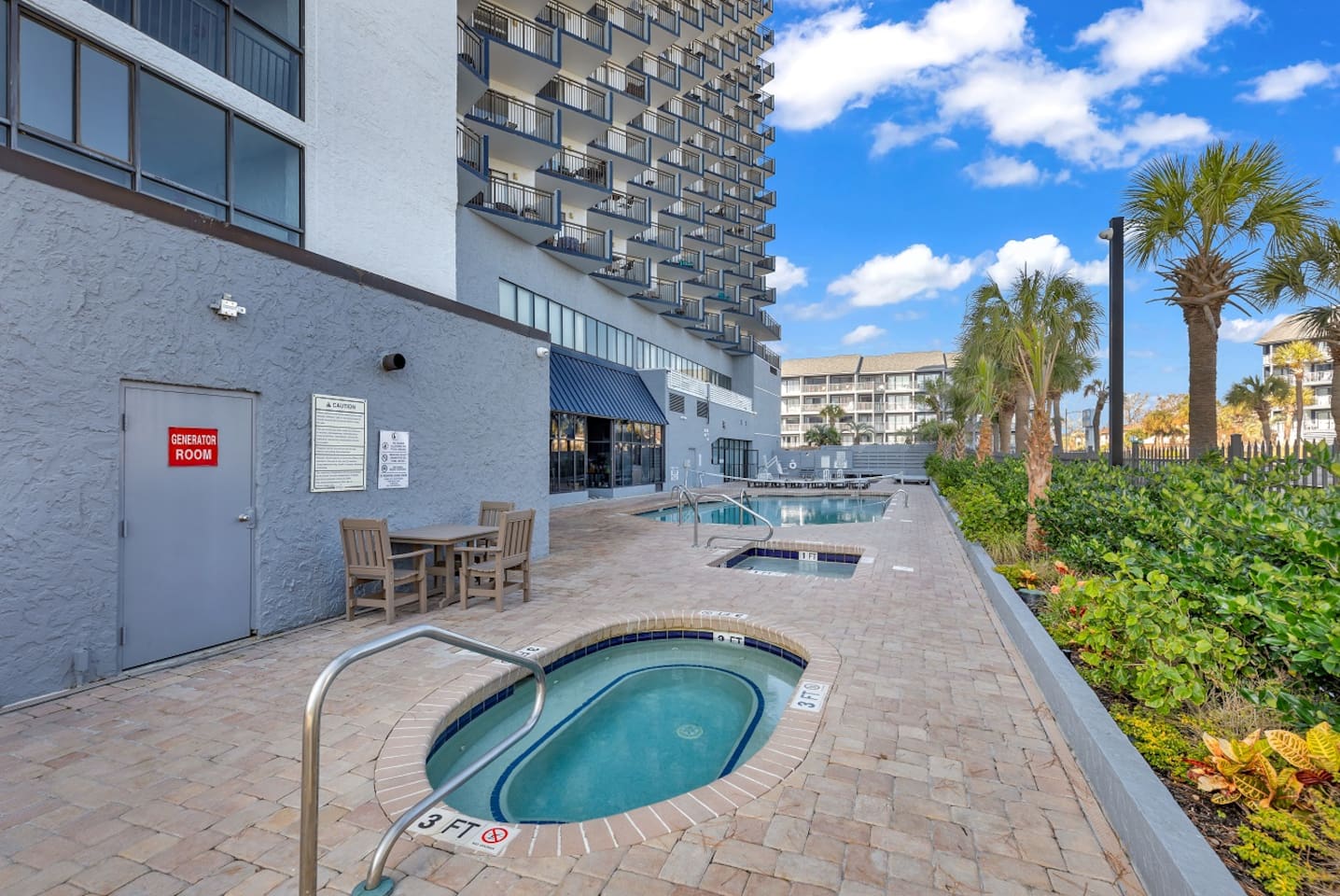 Outdoor Hot Tub, Kiddie pool, and Large Pool w/volleyball net.