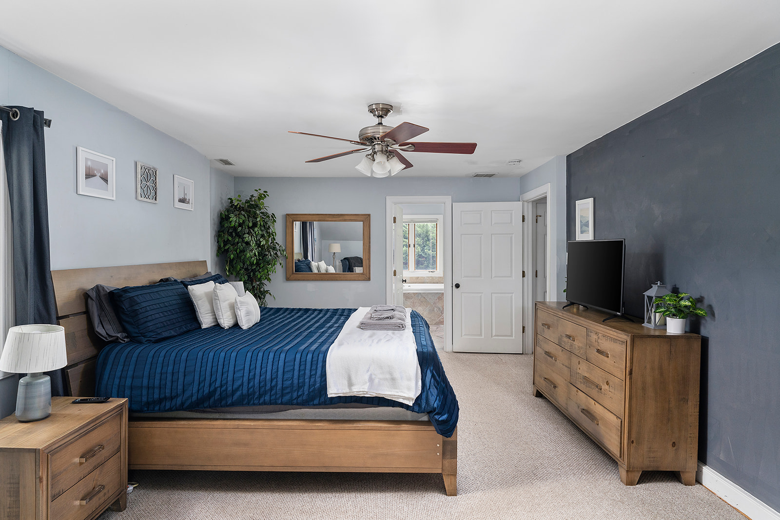 Master Bedroom 1: Stylish decor, sunny views, and a plush bed for restful nights in Richmond!