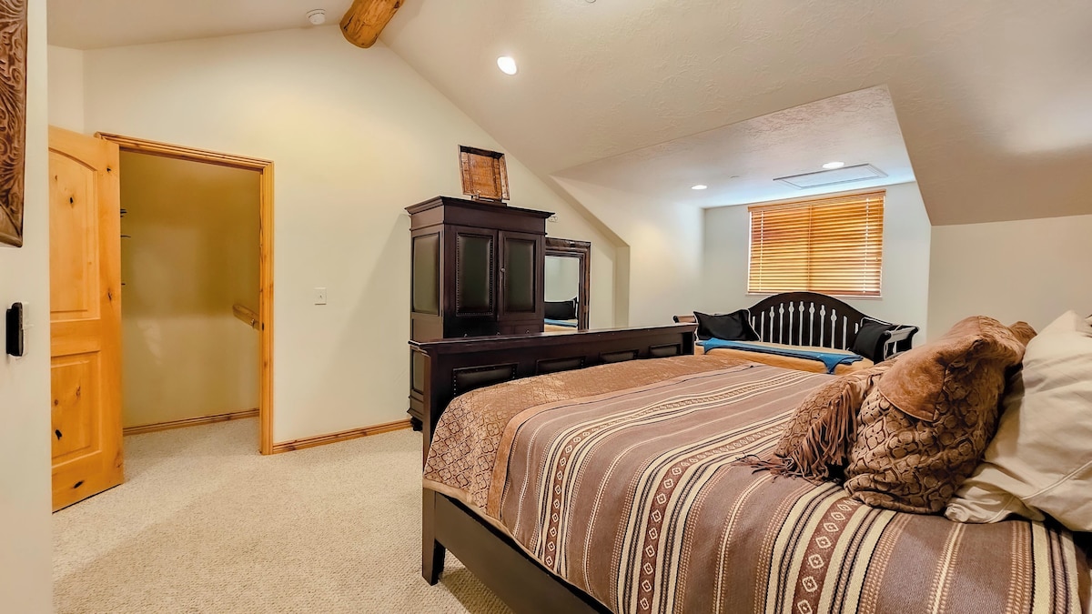 The primary bedroom is outfitted with a king bed, luxurious linens, and plush pillows. There is also a trundle bed for additional guests.