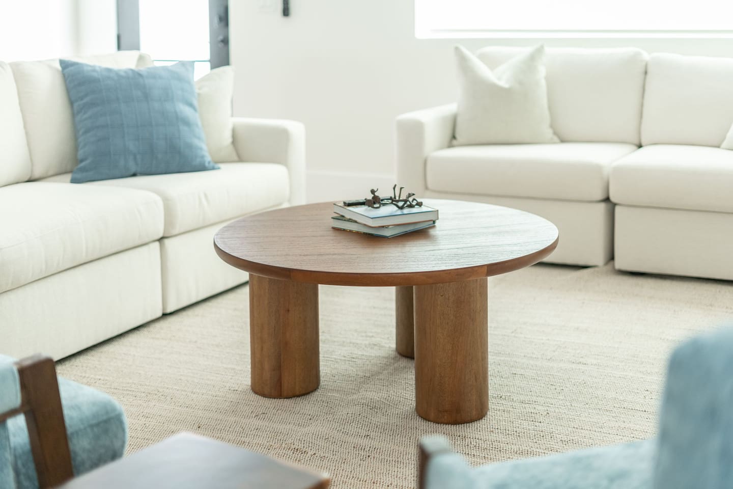 Modern sofa and accent chairs create a cozy spot for movie nights or conversations.