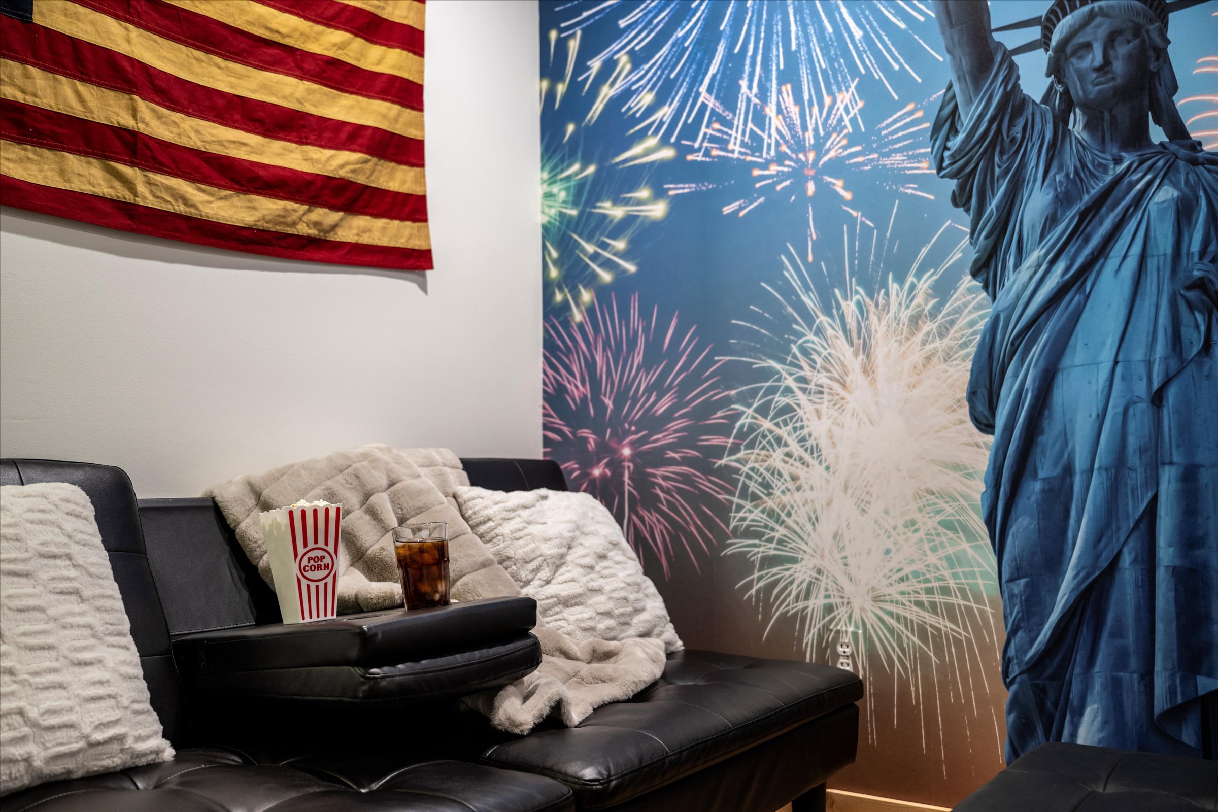 Celebrate America!  The Den has a couch and 70" Smart TV.