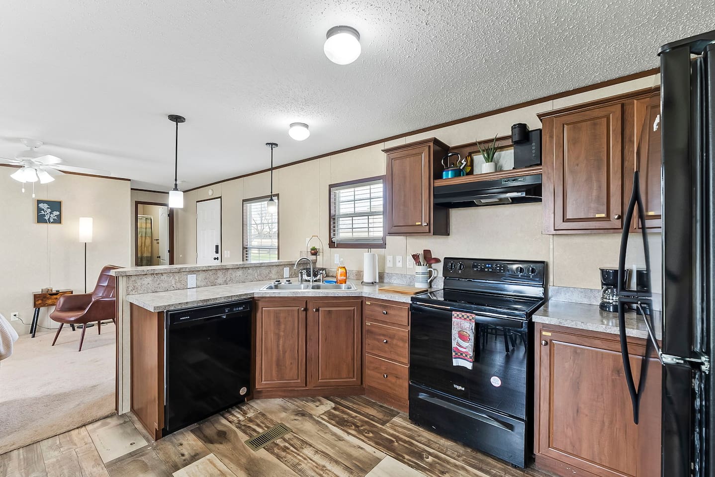 Open-concept kitchen with breakfast bar seating, full appliances, and seamless flow into the living area—perfect for social stays.