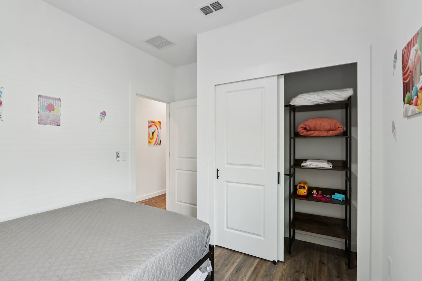 Bedroom has Queen Bed, twin trundle under bed, nightstand, suitcase holder, closet with hangers
