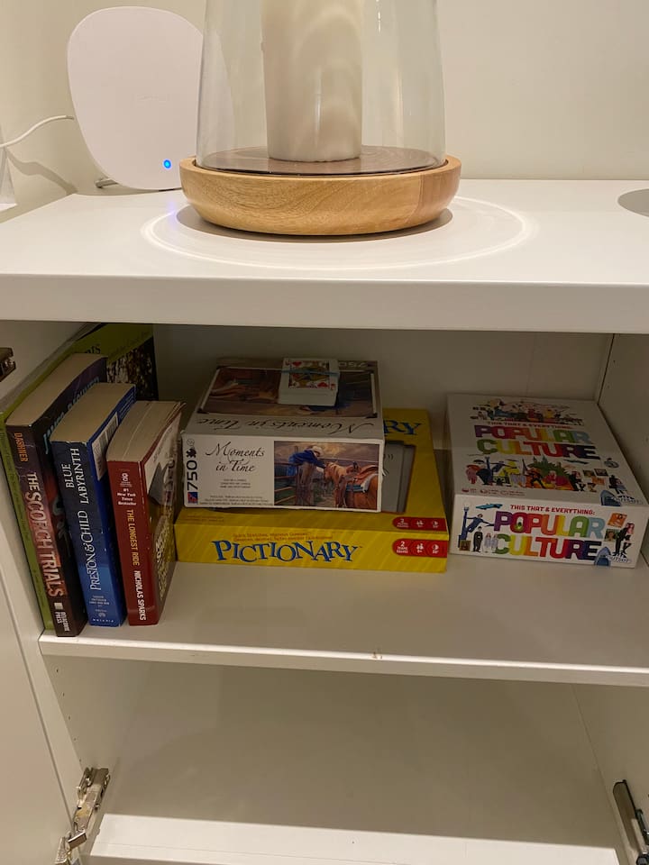 Books and games on the right hand side of the fireplace