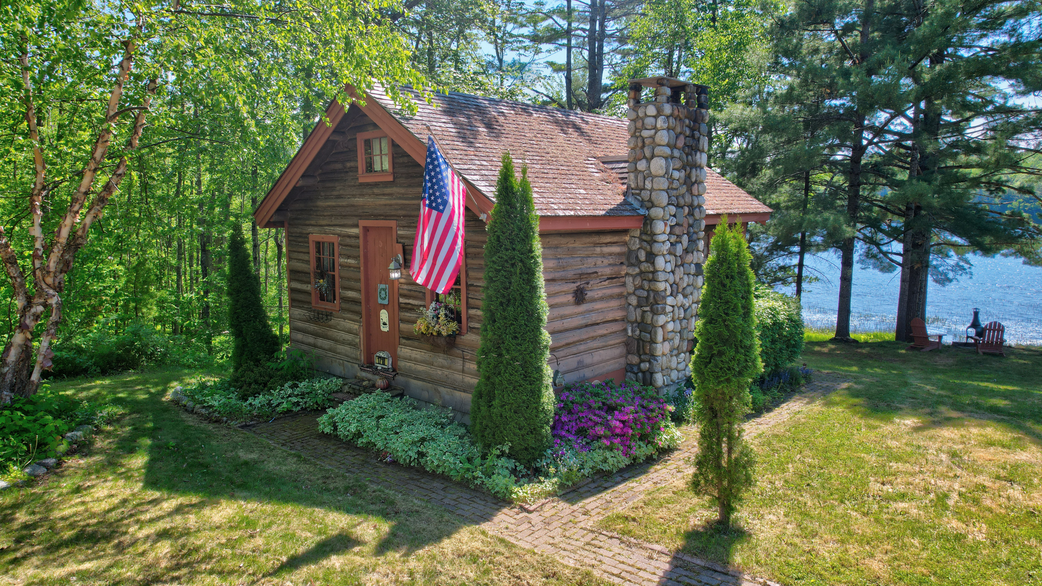 Historic Main log cabin view from above the parking lot towards Long Pond, Maine