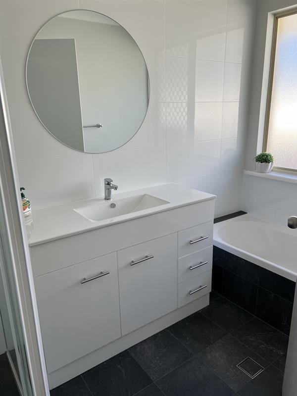 Main bathroom with separate bath tub & vanity
