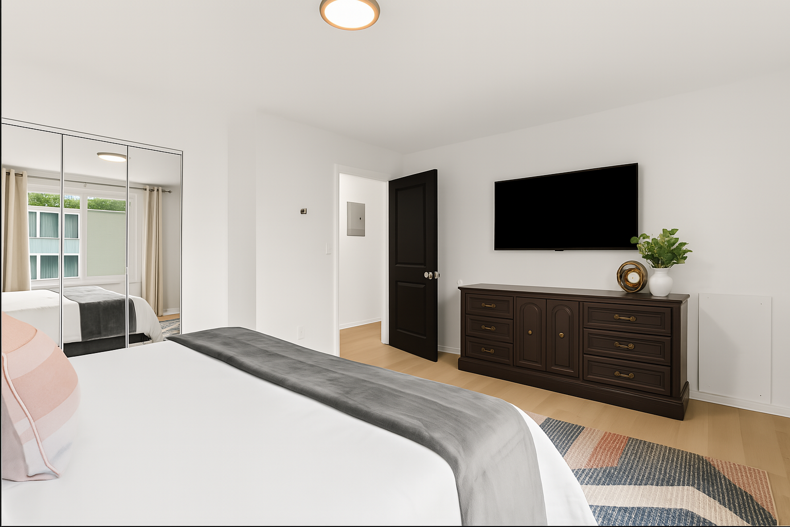 Full bedroom view with relaxing décor, blackout curtains, and private entertainment setup.