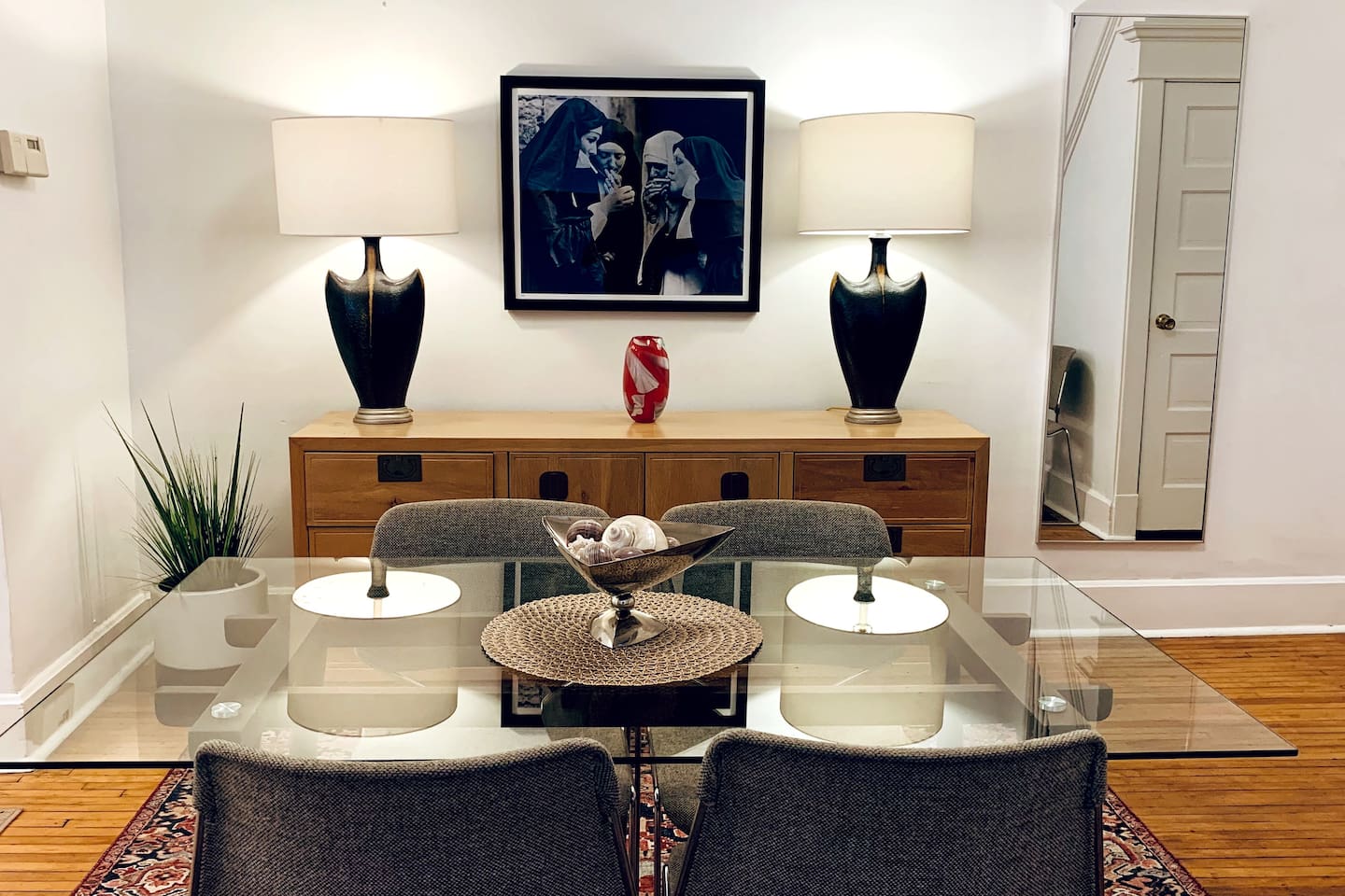 Mid-century modern dining area set within a historic 1920s home, blending classic architectural details with a contemporary, art-forward vibe. Comfortably seats four, with additional chairs available.