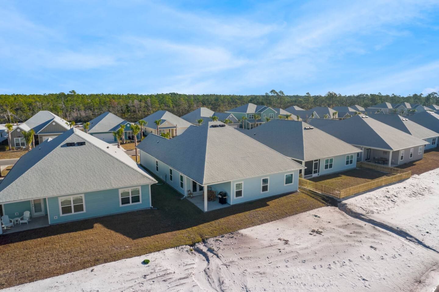 Aerial view of a peaceful coastal community surrounded by nature and water views.