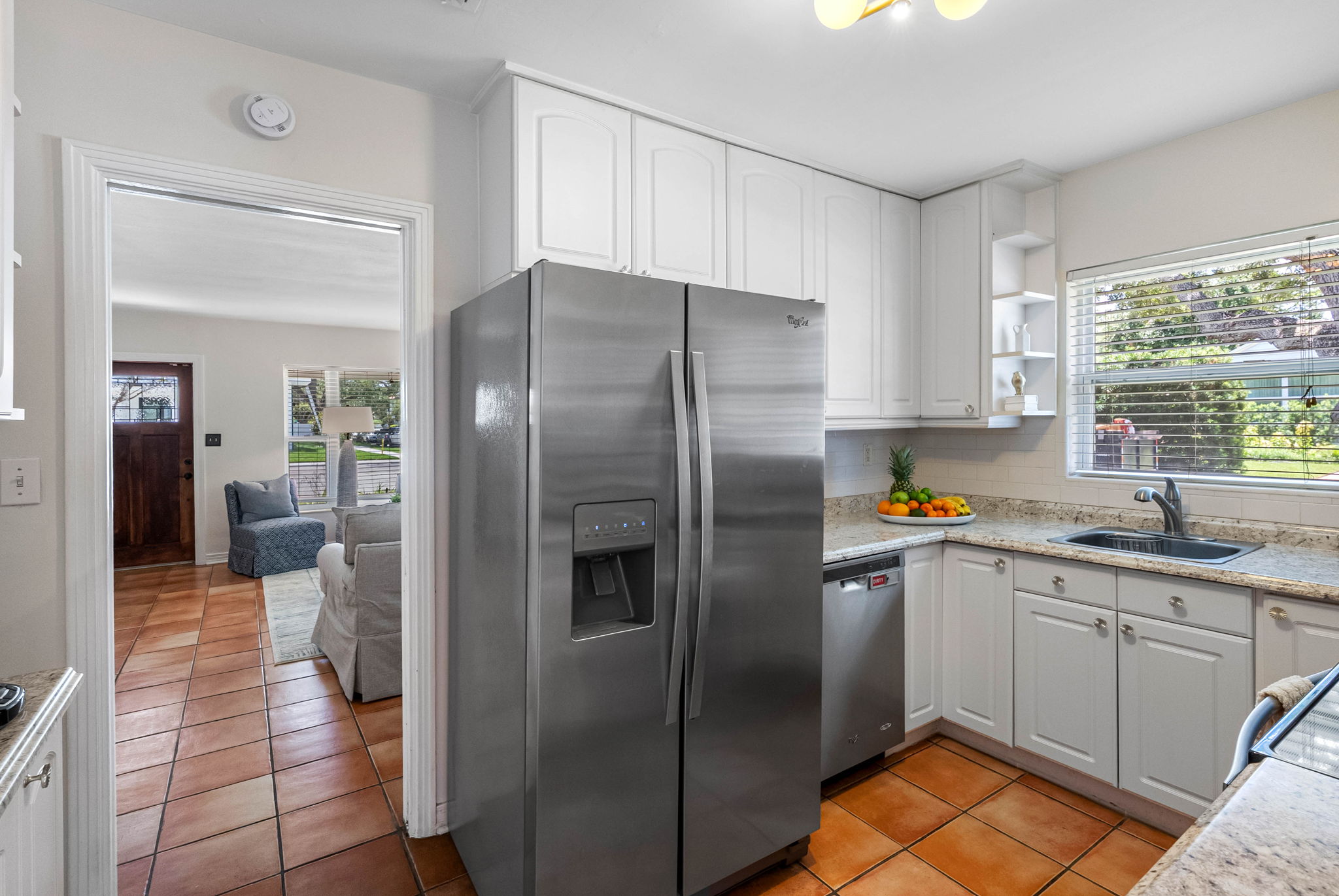 Equipped with a full-size stainless steel Whirlpool range, oven, and built-in microwave, this kitchen is perfect for preparing anything from simple snacks to full family dinners.