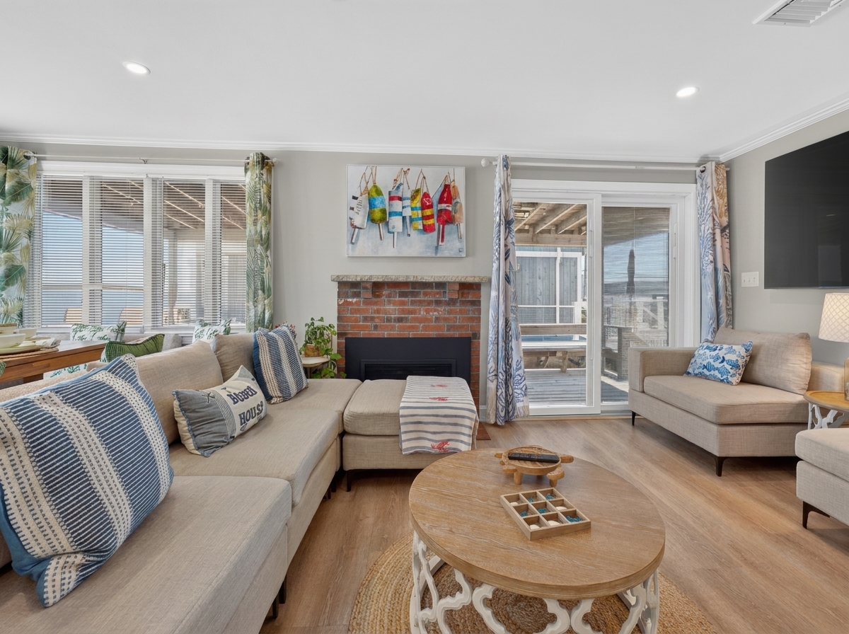 Relax beside the fireplace with comfortable seating and thoughtful coastal touches.