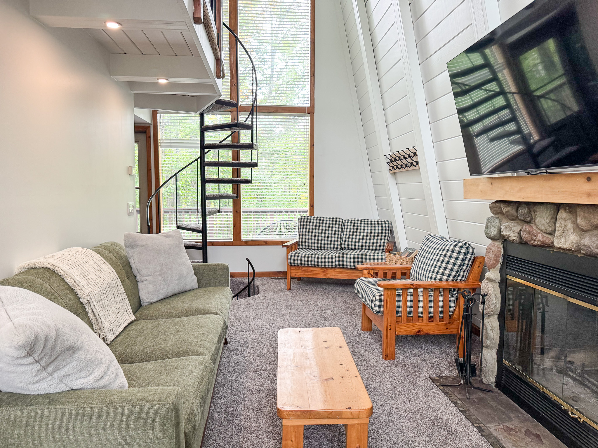 Cozy living room with natural log fireplace and flatscreen tv with streaming