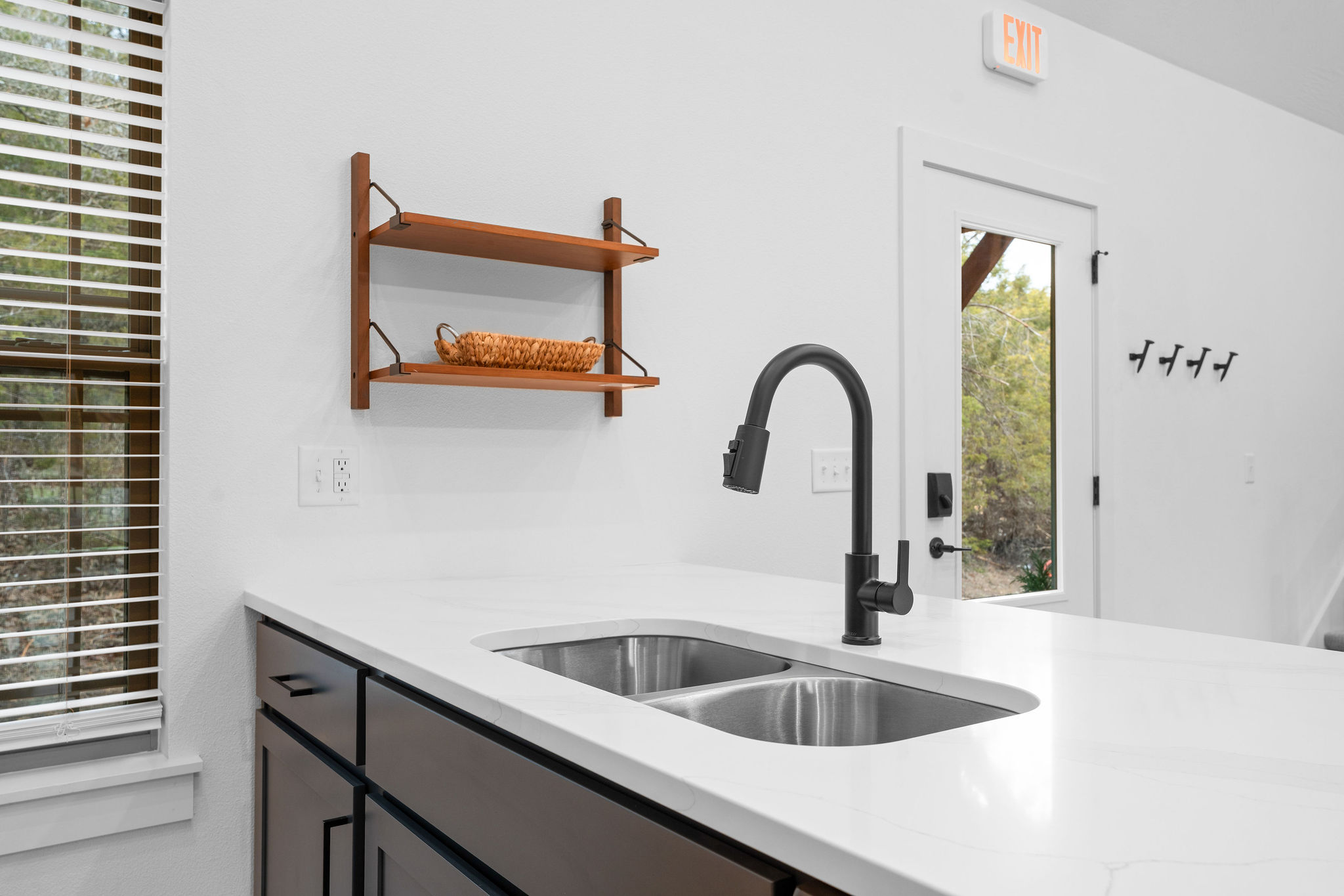Clean, modern sink area with plenty of counter space.
