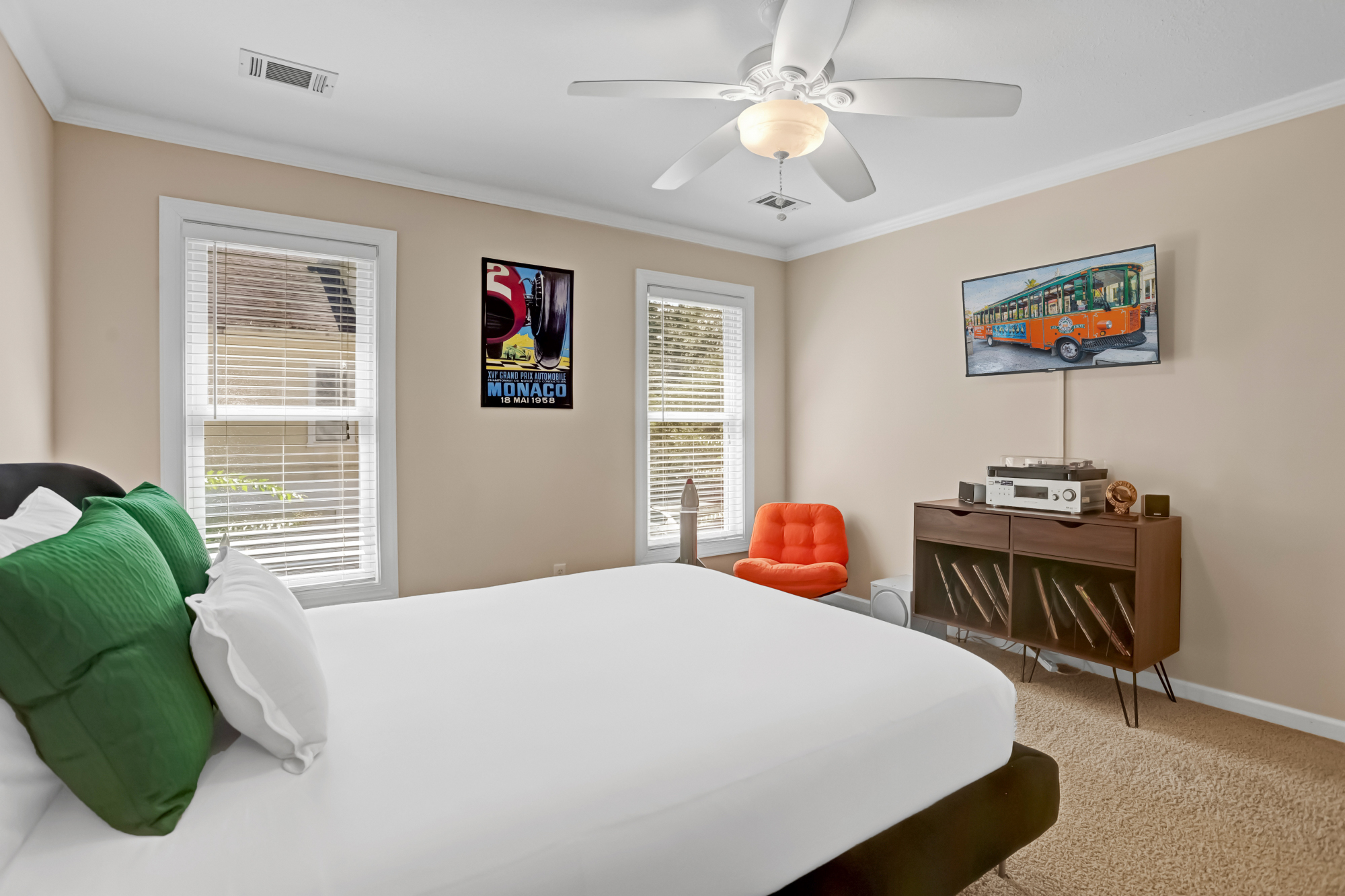 Stylish bedroom with a cozy bed, mid-century modern touches, and a record player for a retro vibe.