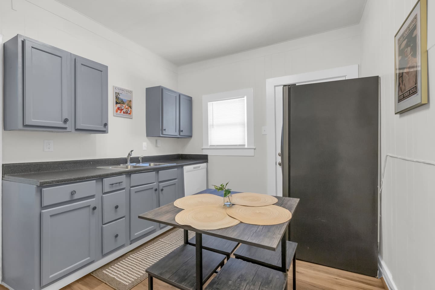 Open kitchen with island style seating and stainless steel appliances.