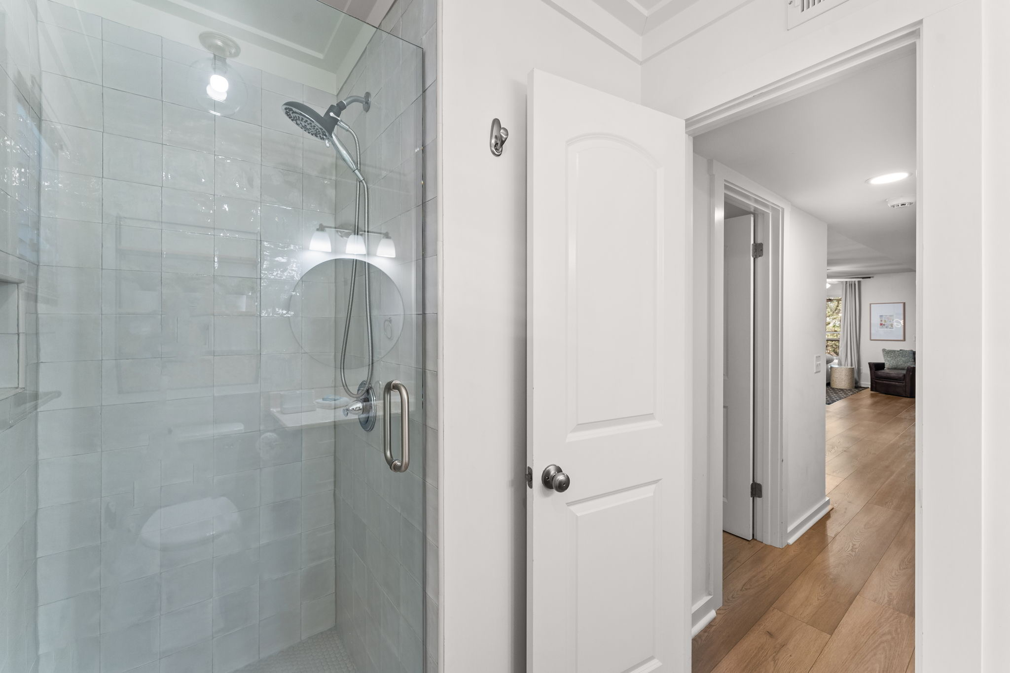 Side A: Convenient 3rd-floor hall bath featuring fresh updates and sleek tile.