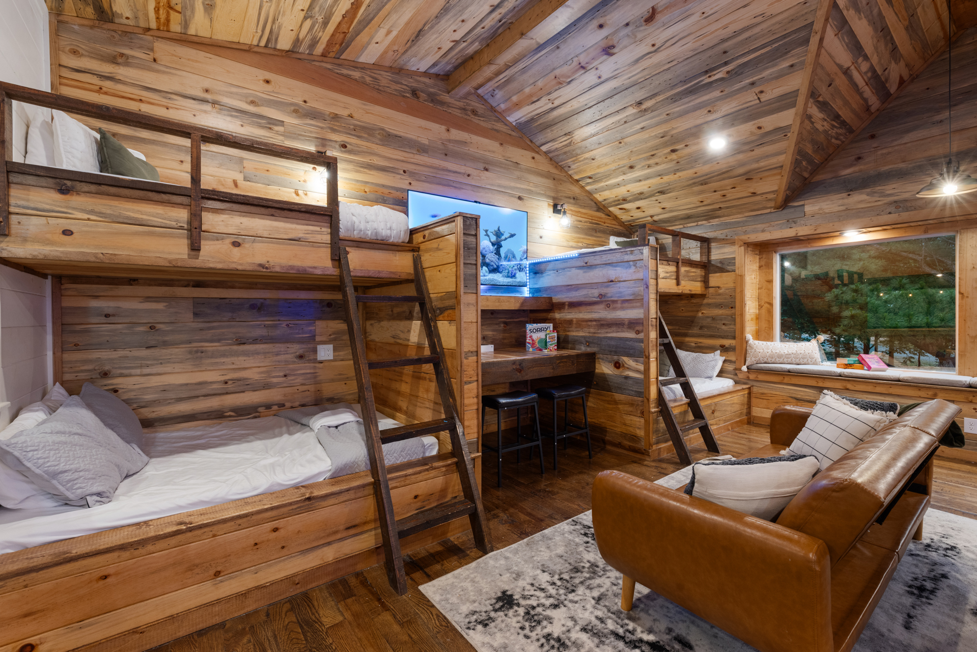 Built in bunks and cabin sleepover vibes done right. 
Perfect for kids, and late night storytelling after a full day of arcade battles and game room fun upstairs.