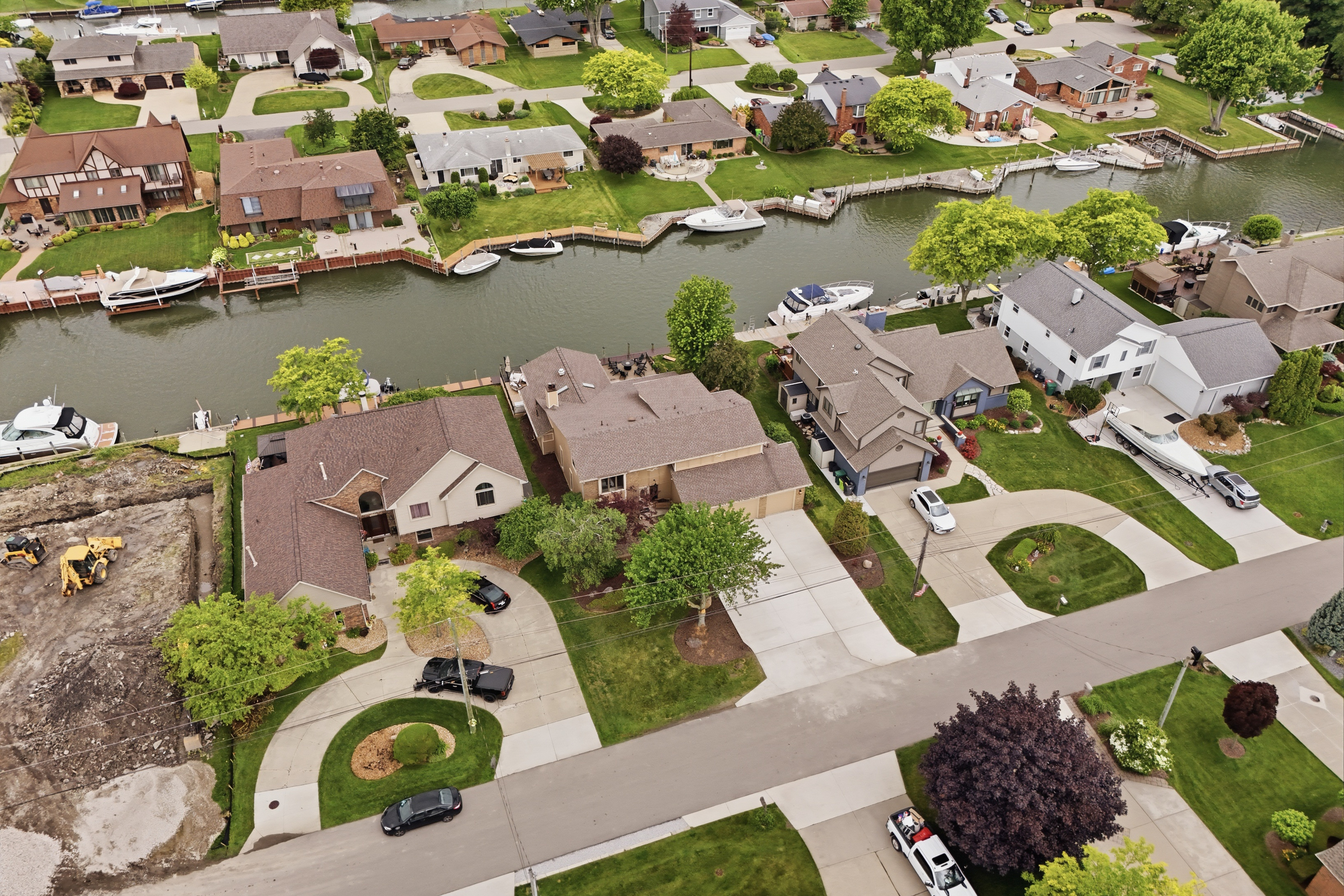 Aerial view of a quiet waterfront neighborhood with canal access, private docks, and well-maintained homes in a peaceful suburban setting.