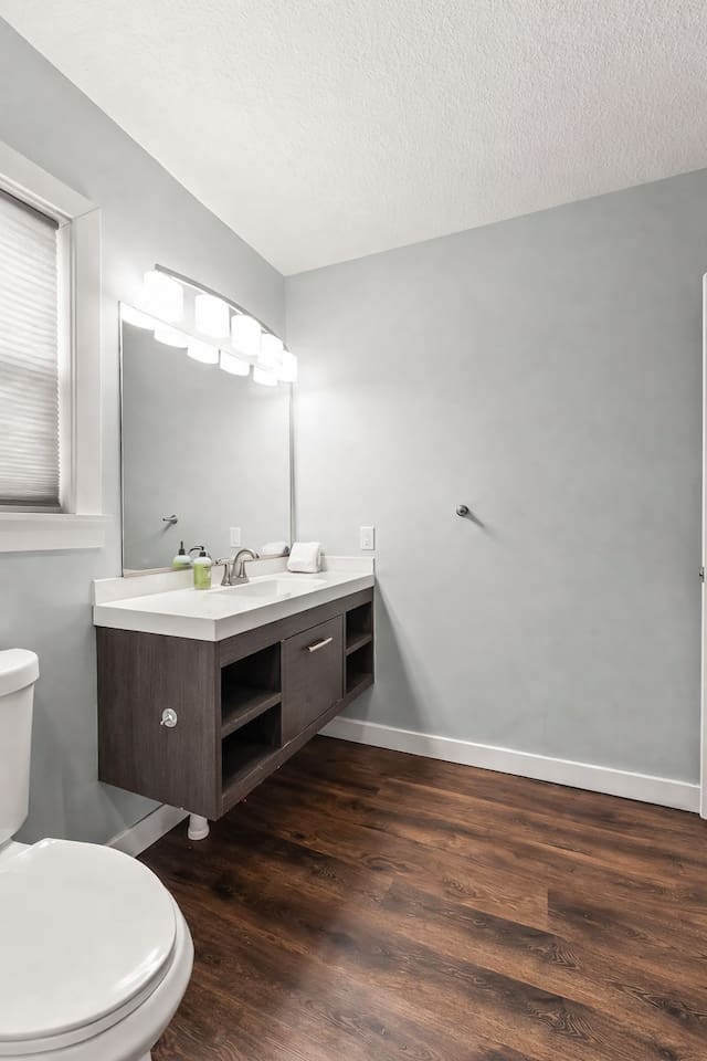 Clean vanity area with large mirror, contemporary lighting, and plenty of counter space for daily routines.