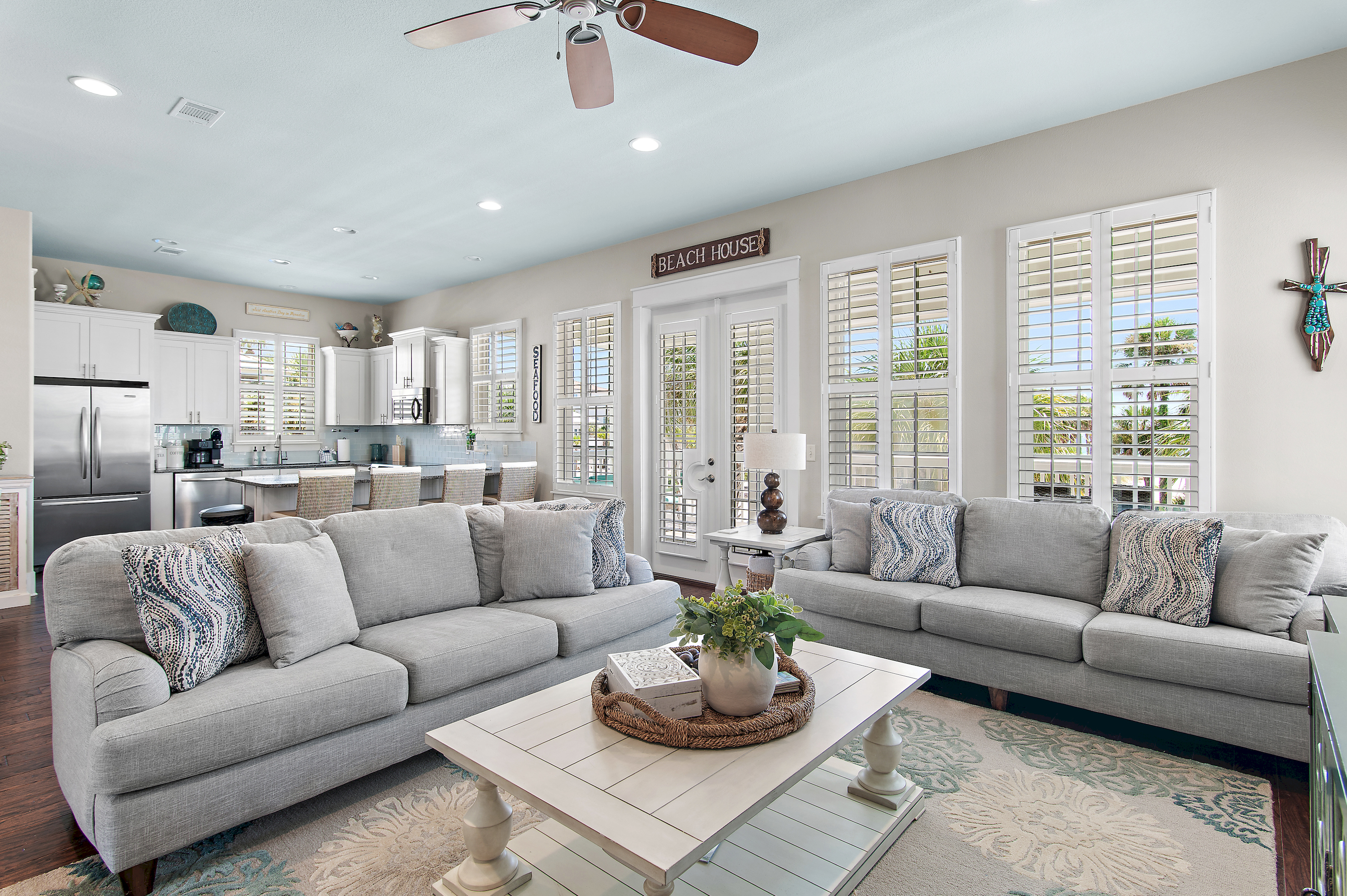 Relax in a bright, coastal-inspired living room designed for comfort after a day at the beach.