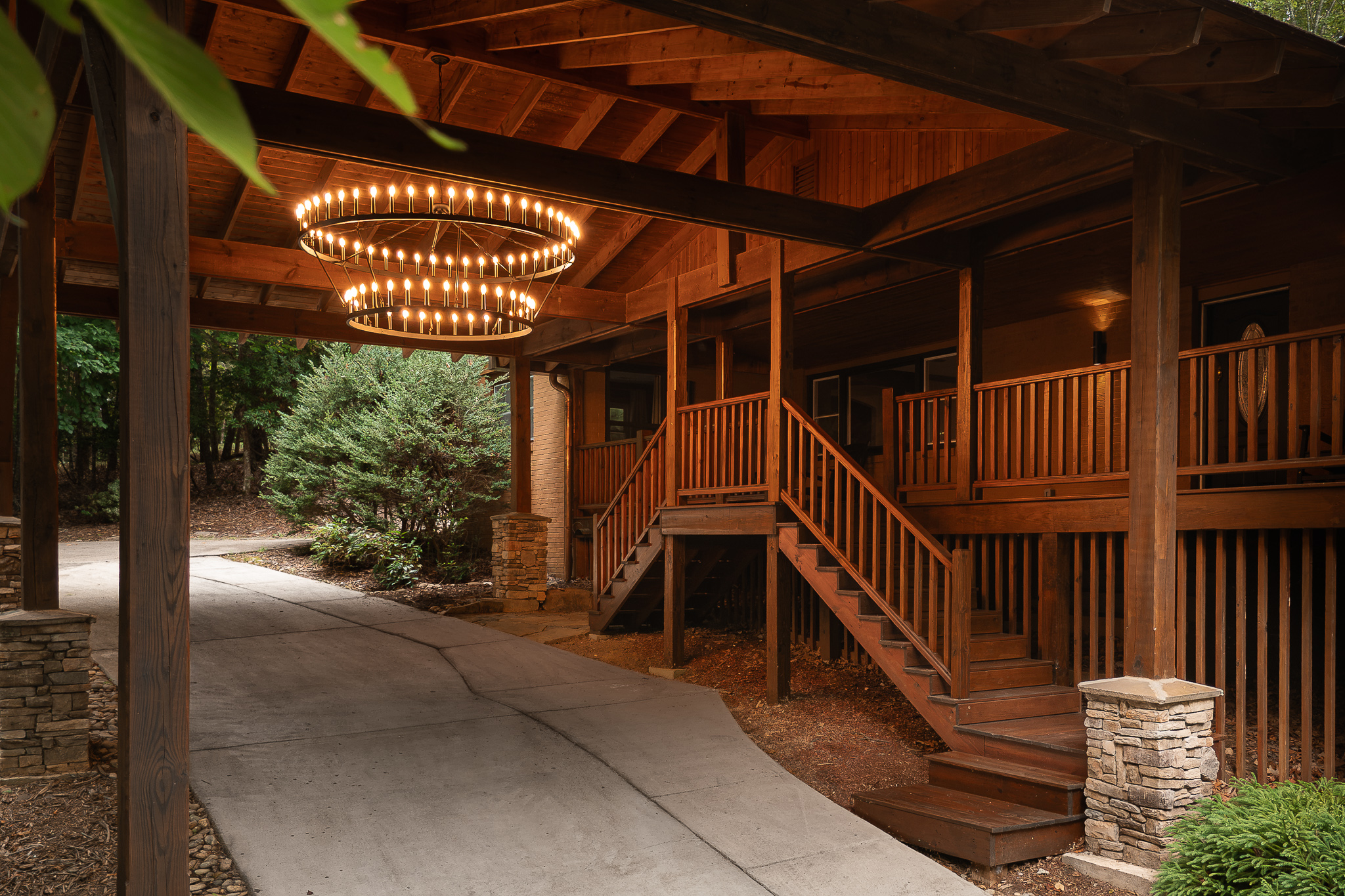 {Covered Entry} Arrive beneath the dramatic timber porte-cochère, with a sheltered entrance that sets the mountain-lodge tone from the moment you pull in.