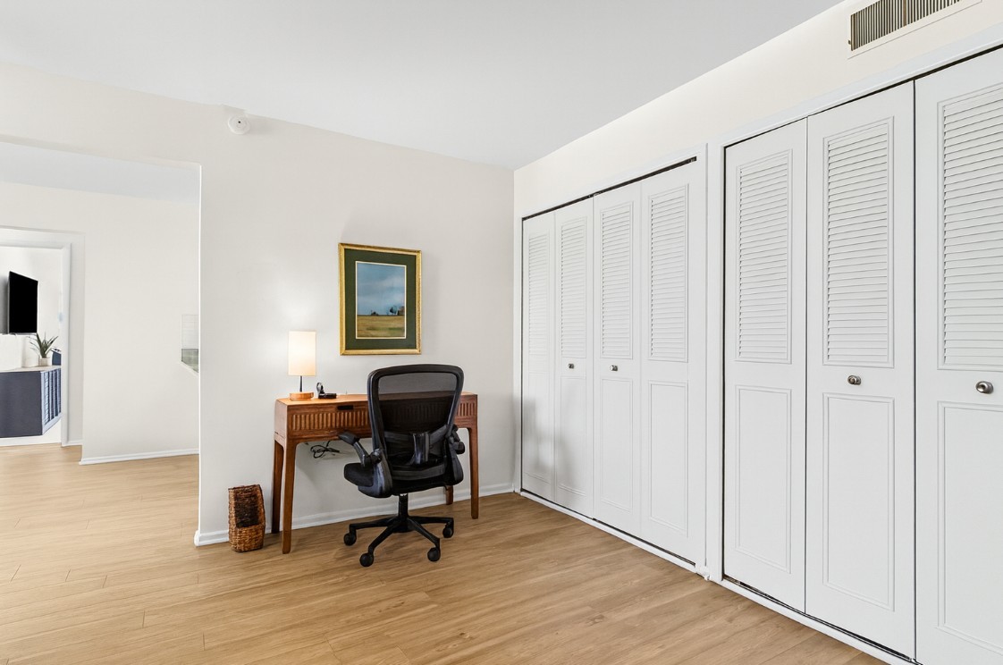Well-lit workstation with desk, ergonomic chair, and charging access—ready for productivity.
