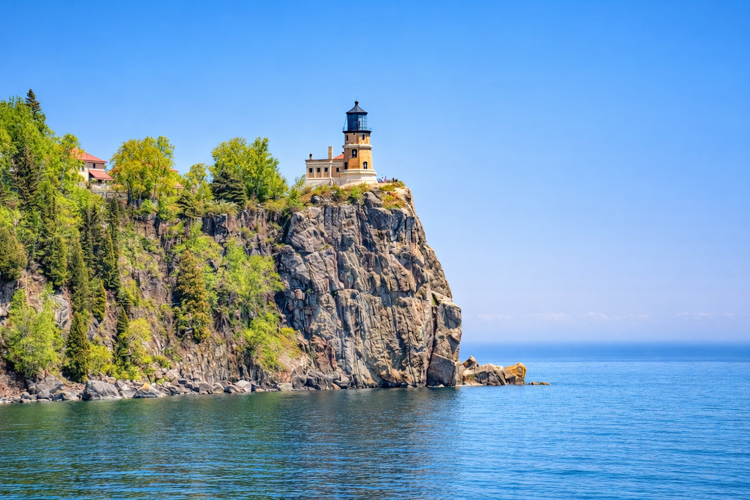 Split Rock Lighthouse the iconic North Shore view rising dramatically from the rocky shoreline. Seen from the beach with the lighthouse perched on the ledge above Lake Superior, this is a must-see stop and just 10 minute drive from Trail Shack.