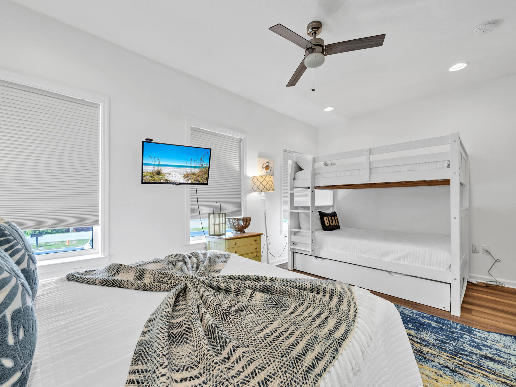 Secondary queen bedroom with queen over queen bunk beds and ensuite bath