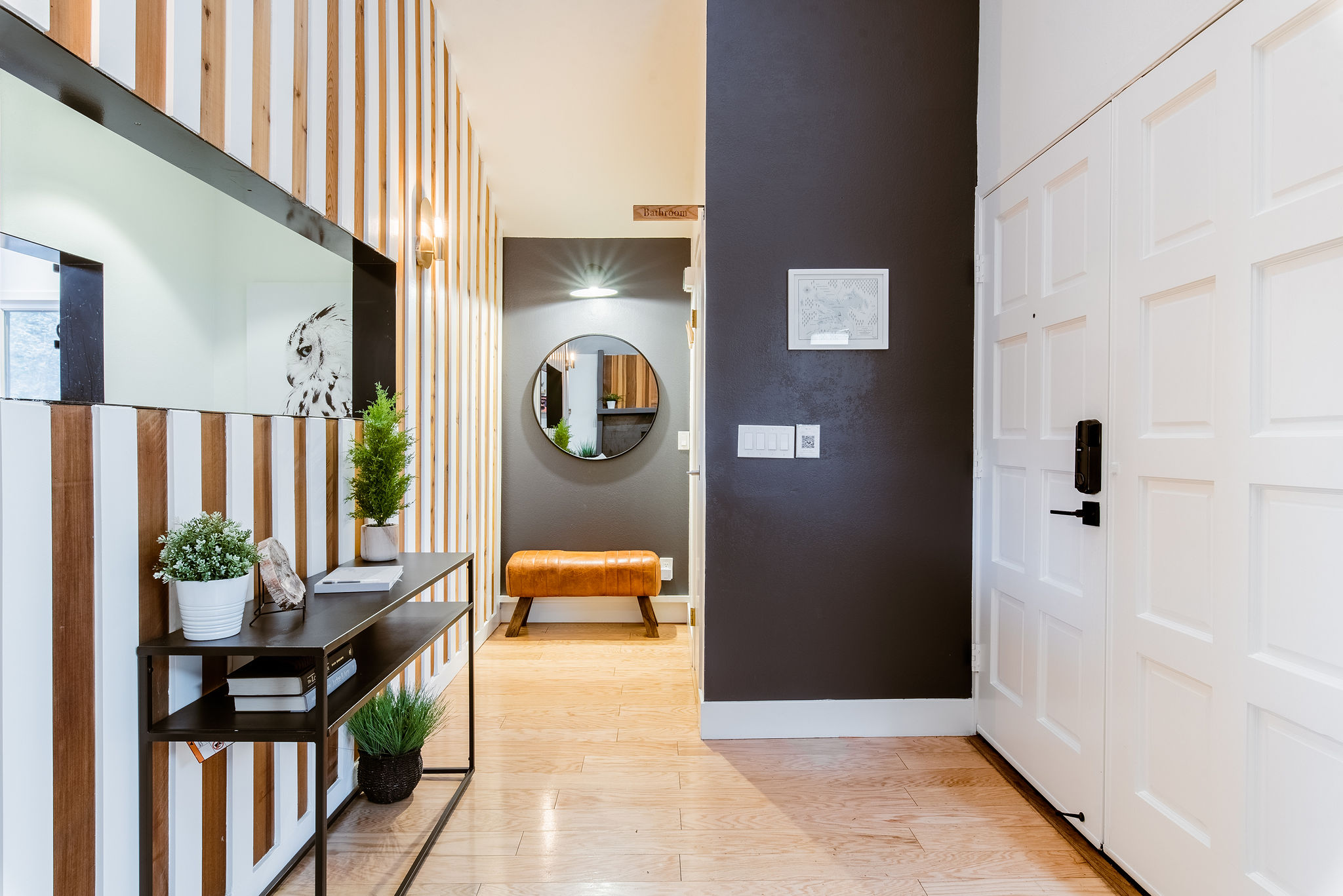 The first look as you enter into your spacious tri-level, modern open floor plan Treetop Cabin. The entry is on the top floor with a bathroom tucked away on your right.
