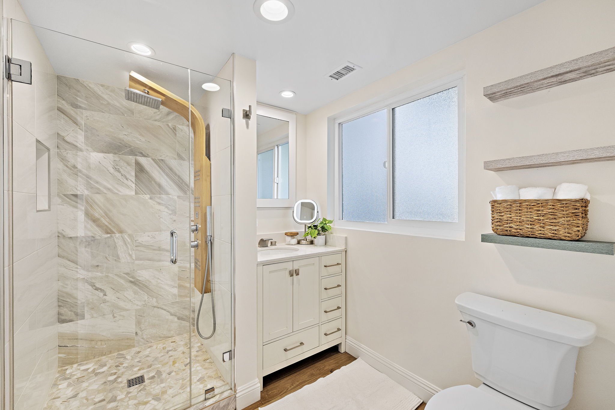 Indulge in a spa-like experience with this elegant walk-in shower and custom tilework.