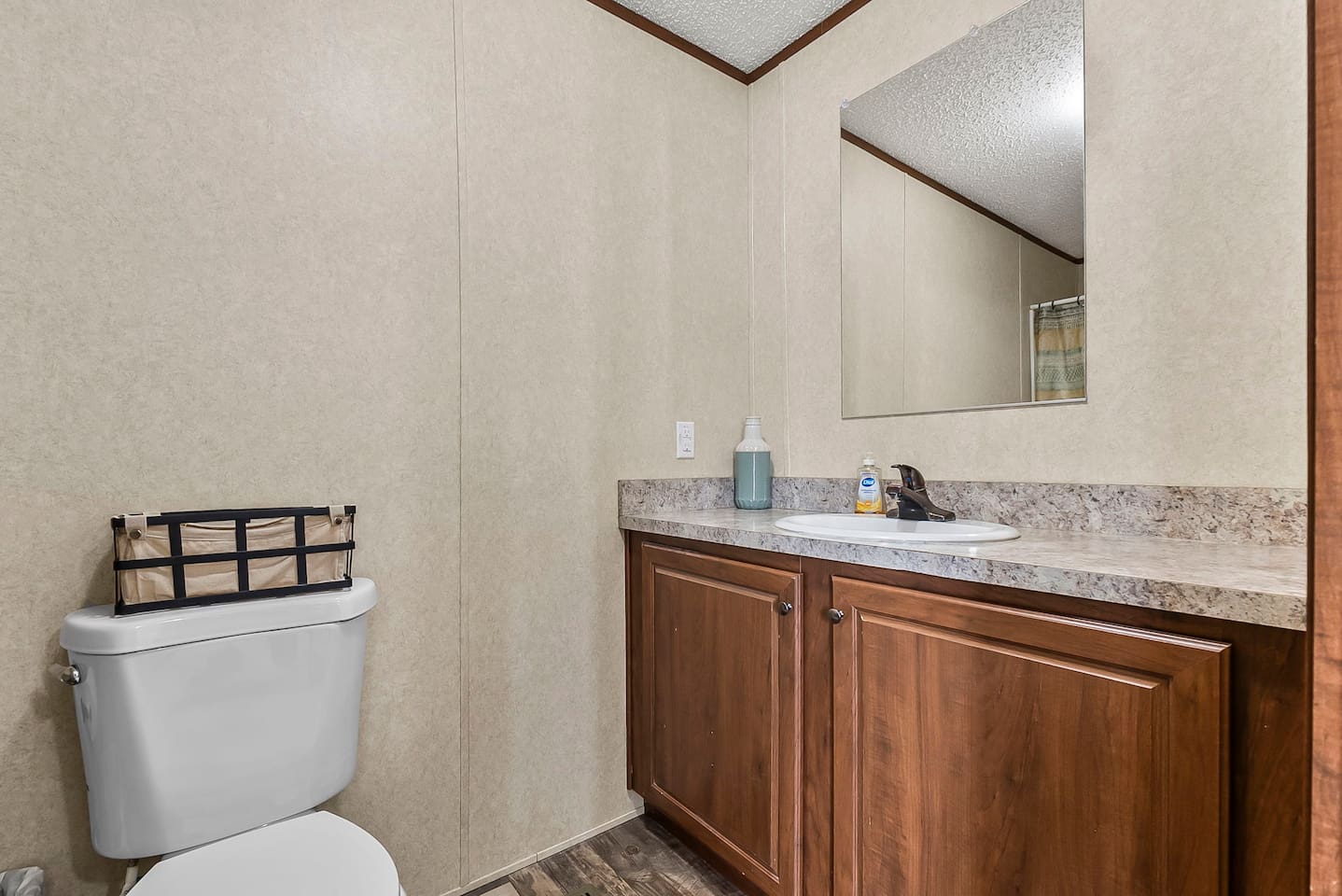 Clean and functional bathroom with a spacious vanity, large mirror, and ample counter space for your daily routine.