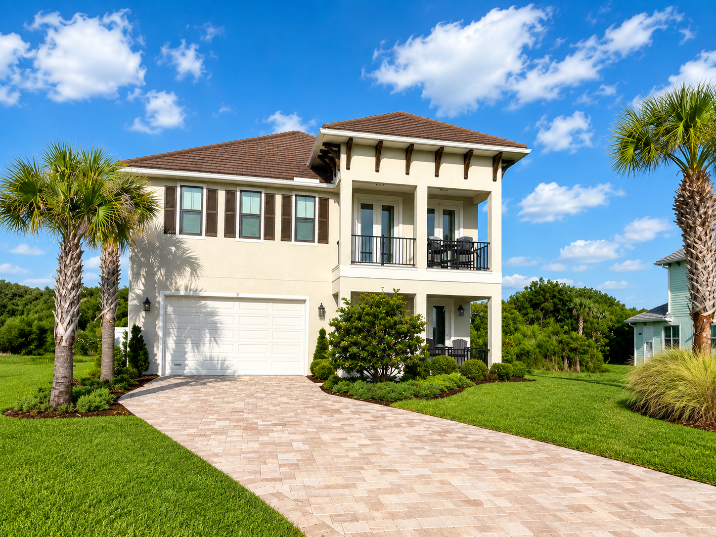 Sun on the stucco, palms overhead, and a paver drive that says you've arrived somewhere special. This is the home that gathers your family in—porch rockers for slow mornings, a balcony for golden evenings, and room for everyone in between.