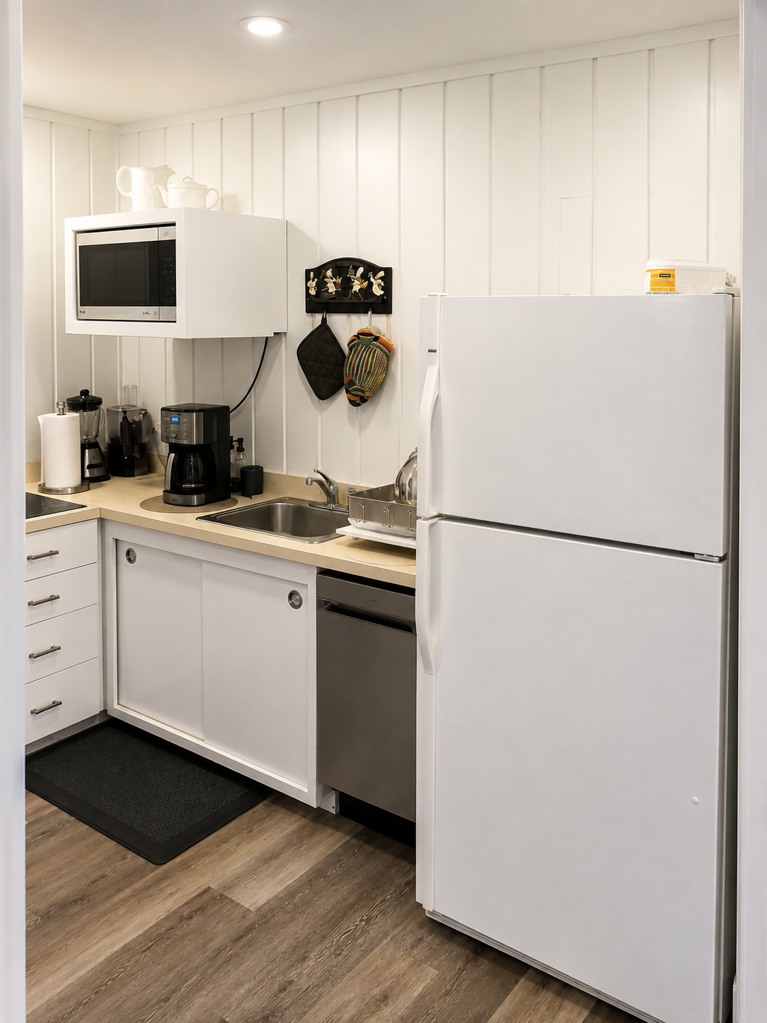 Fully equipped kitchen with a dishwasher, refrigerator, microwave, coffee maker, and small appliances for easy meal prep and everyday convenience.