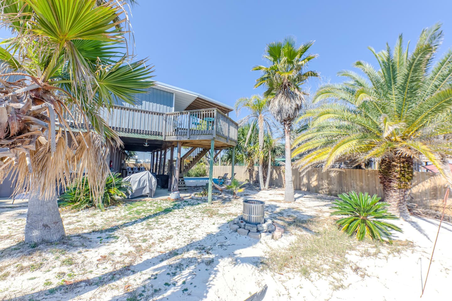 Outdoor Oasis: Enjoy sun-soaked days beneath palm trees and starry nights by the fire pit!