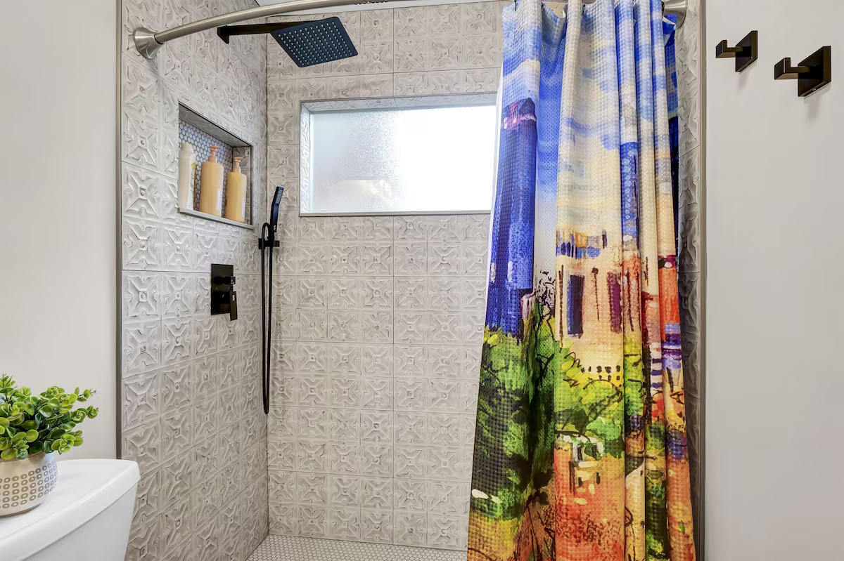 The custom tiled shower provides plenty of room to start or end your day comfortably.