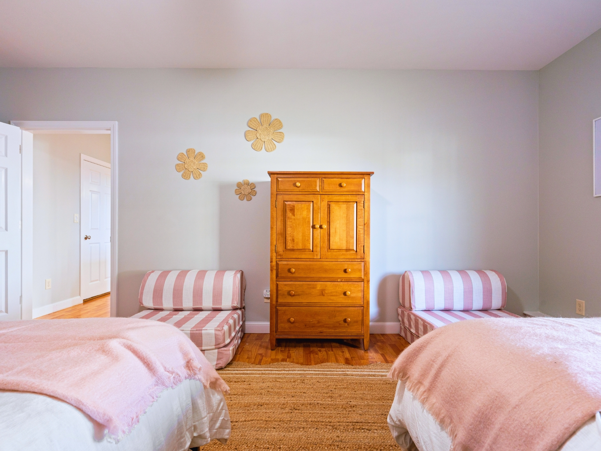 The first bedroom in the basement is perfect for your stay, with two queen beds and two twin beds—comfort and space for all!