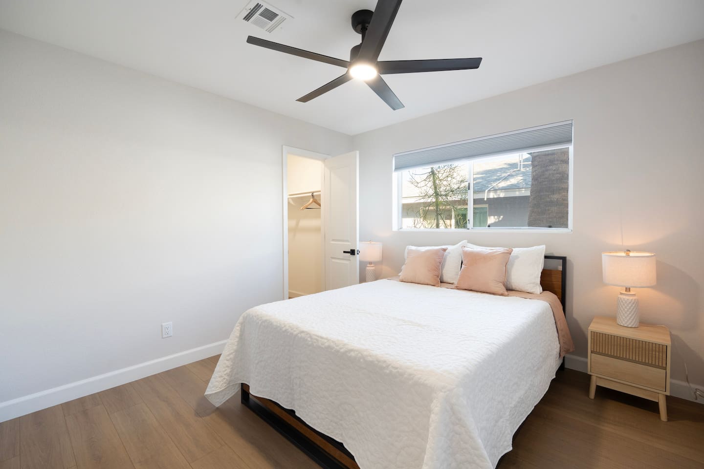 Bright, serene bedroom with plush bedding and soft lighting—designed for restful nights.