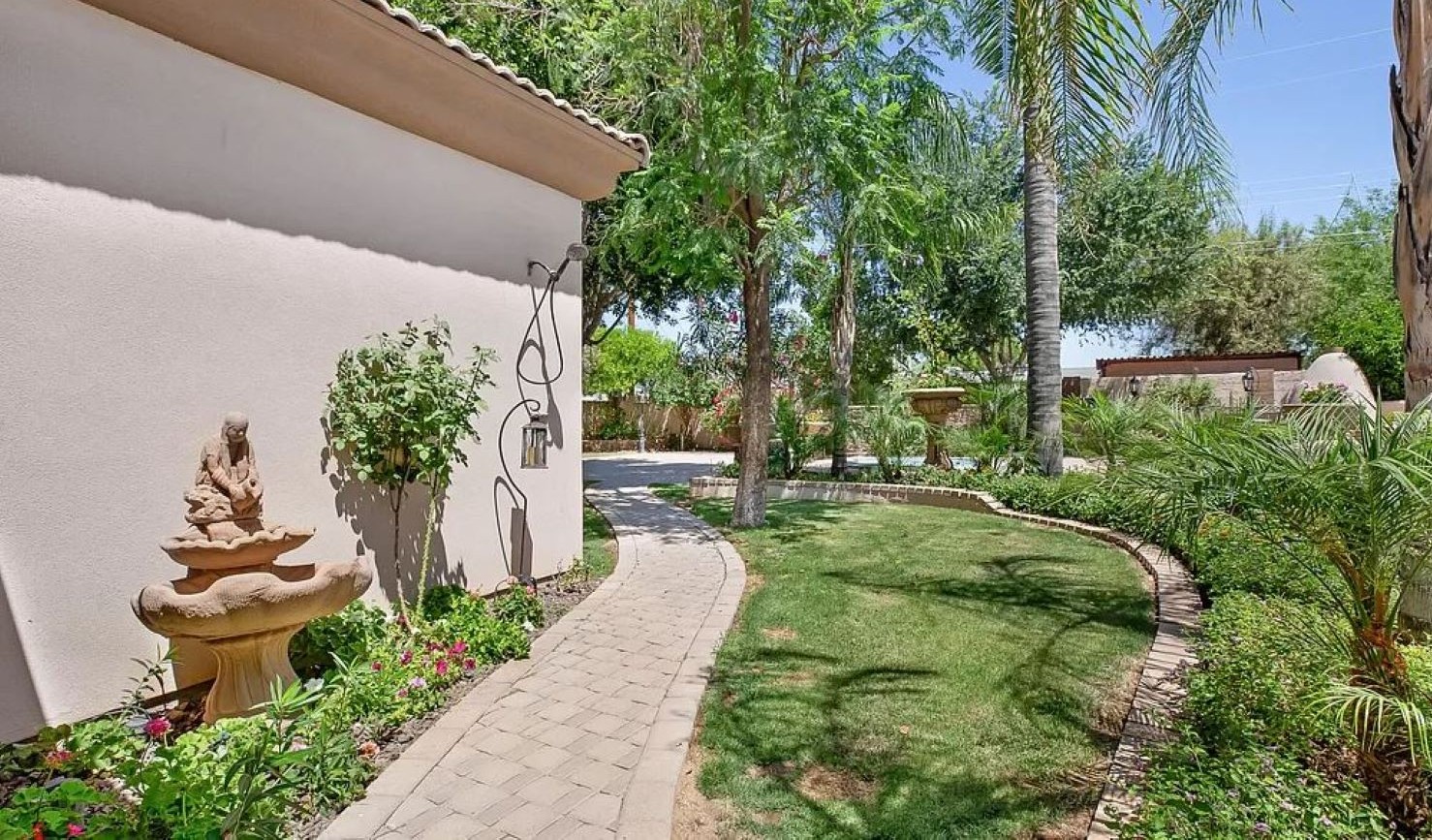 Stroll through this tranquil garden path framed by tropical greenery and desert charm, the perfect start to your peaceful escape.