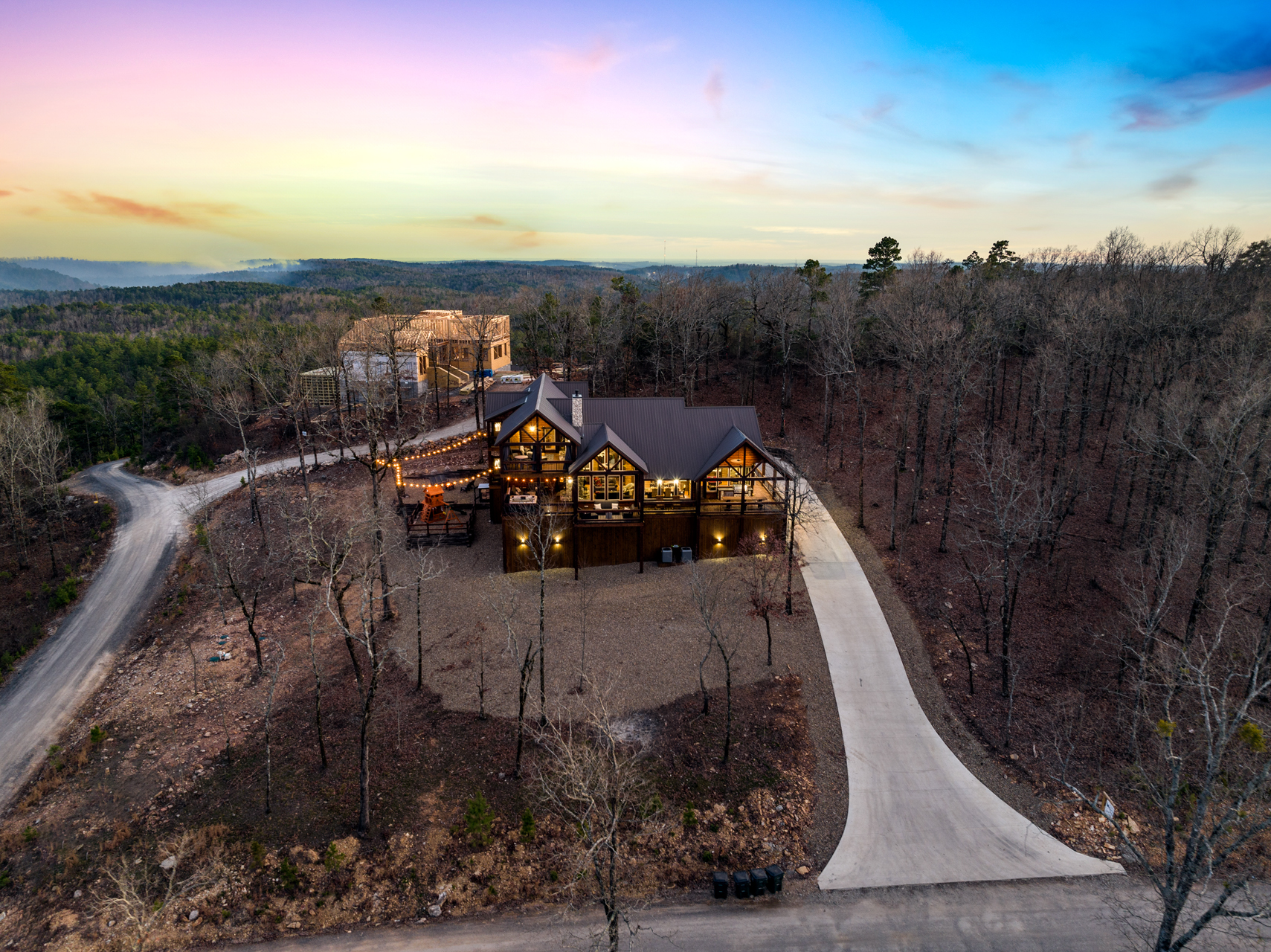 Aerial view showcasing the cabin’s private wooded setting and expansive layout