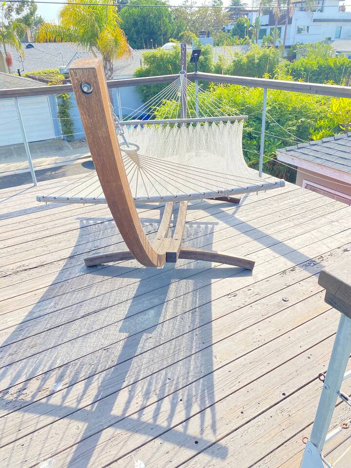 Rooftop deck with hammock and open views of the neighborhood.