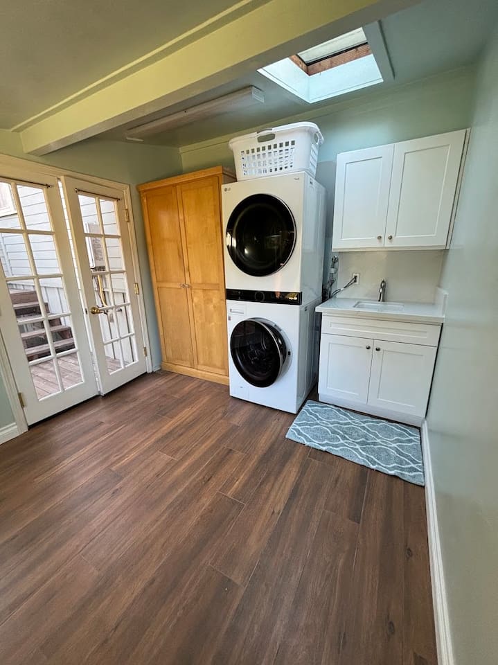 Detached laundry room accessed by back deck.