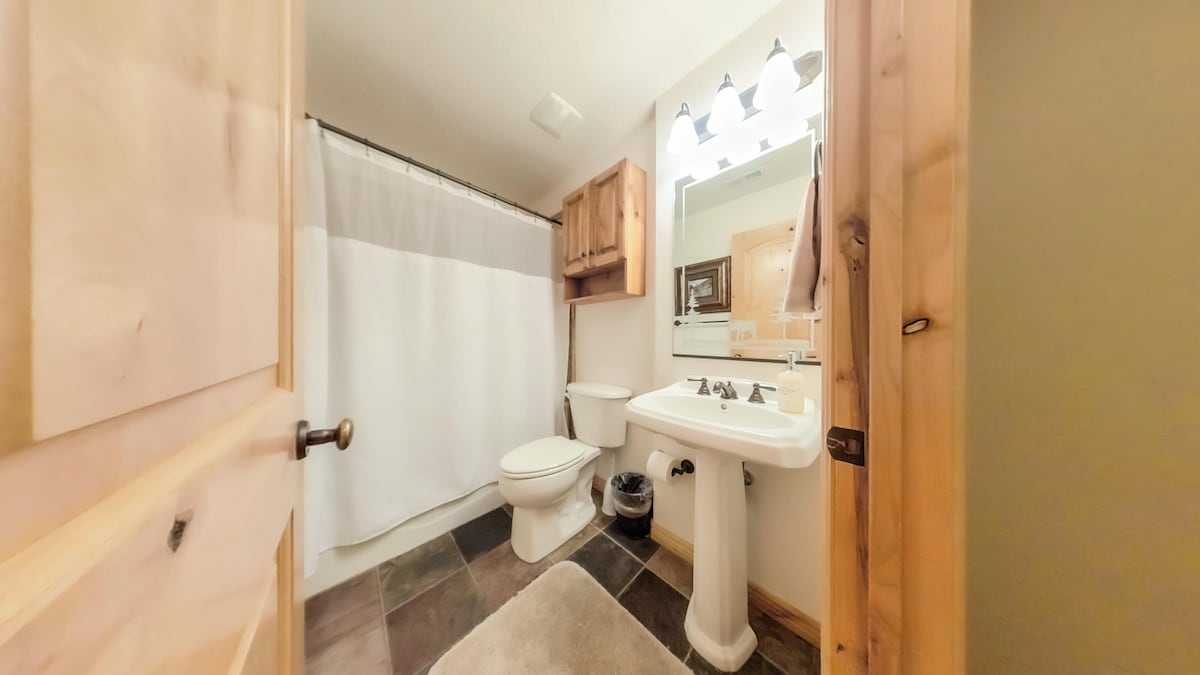 The second bathroom has a combined shower and bathtub. 