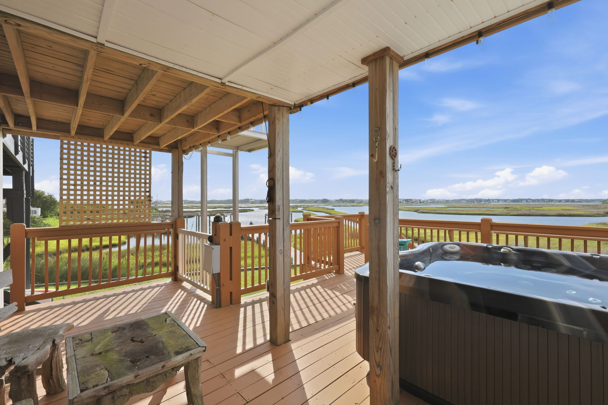 Private deck, bubbling hot tub, and endless water views—vacation perfection.