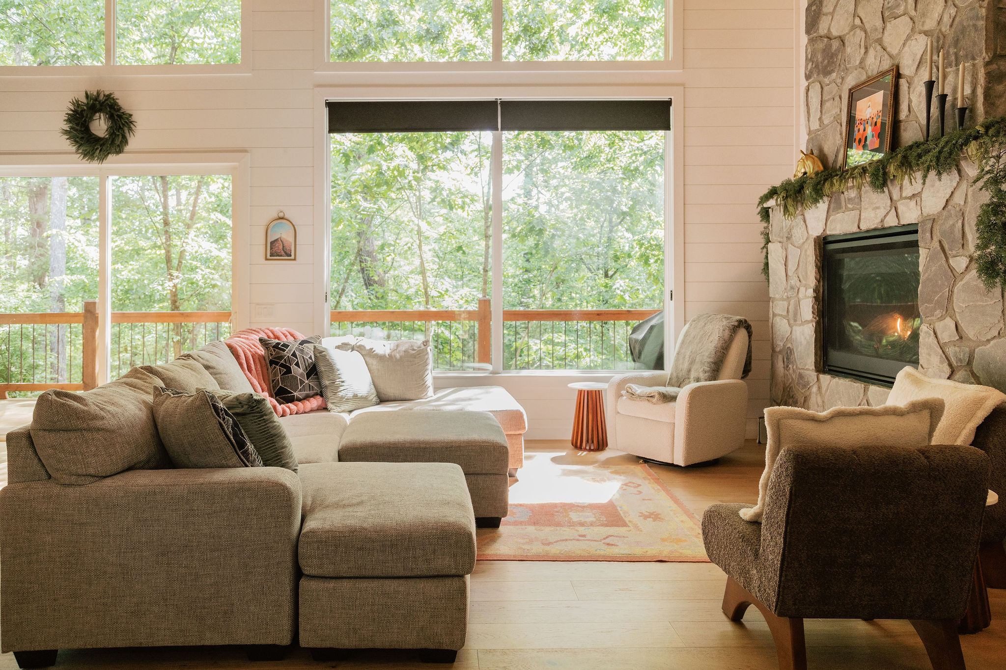 Main cabin living room with large windows and forest views.