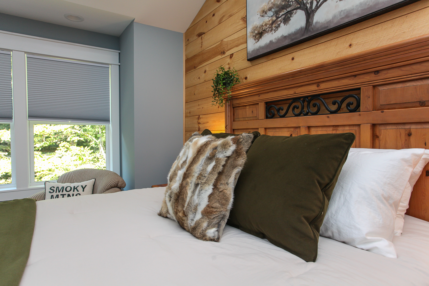 Bedside lamps and layered pillows create a comfortable, inviting retreat in this queen bedroom at Robbin’s Nest on Snowbird Creek.
