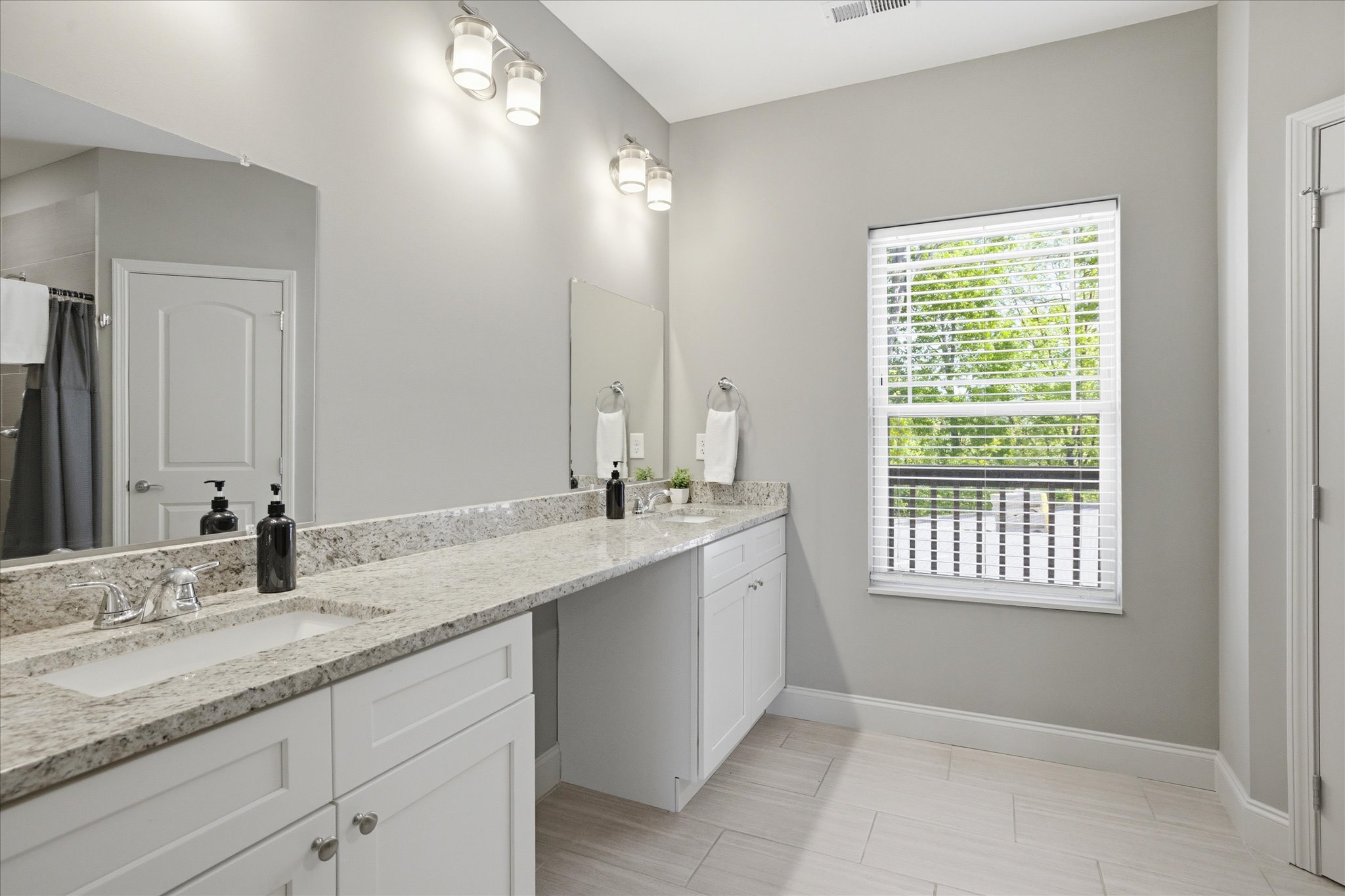 Unit 2's guest bathroom gives you space to move—double sinks, clean finishes, and a layout that keeps mornings from turning into a shuffle. It’s practical in the best way.