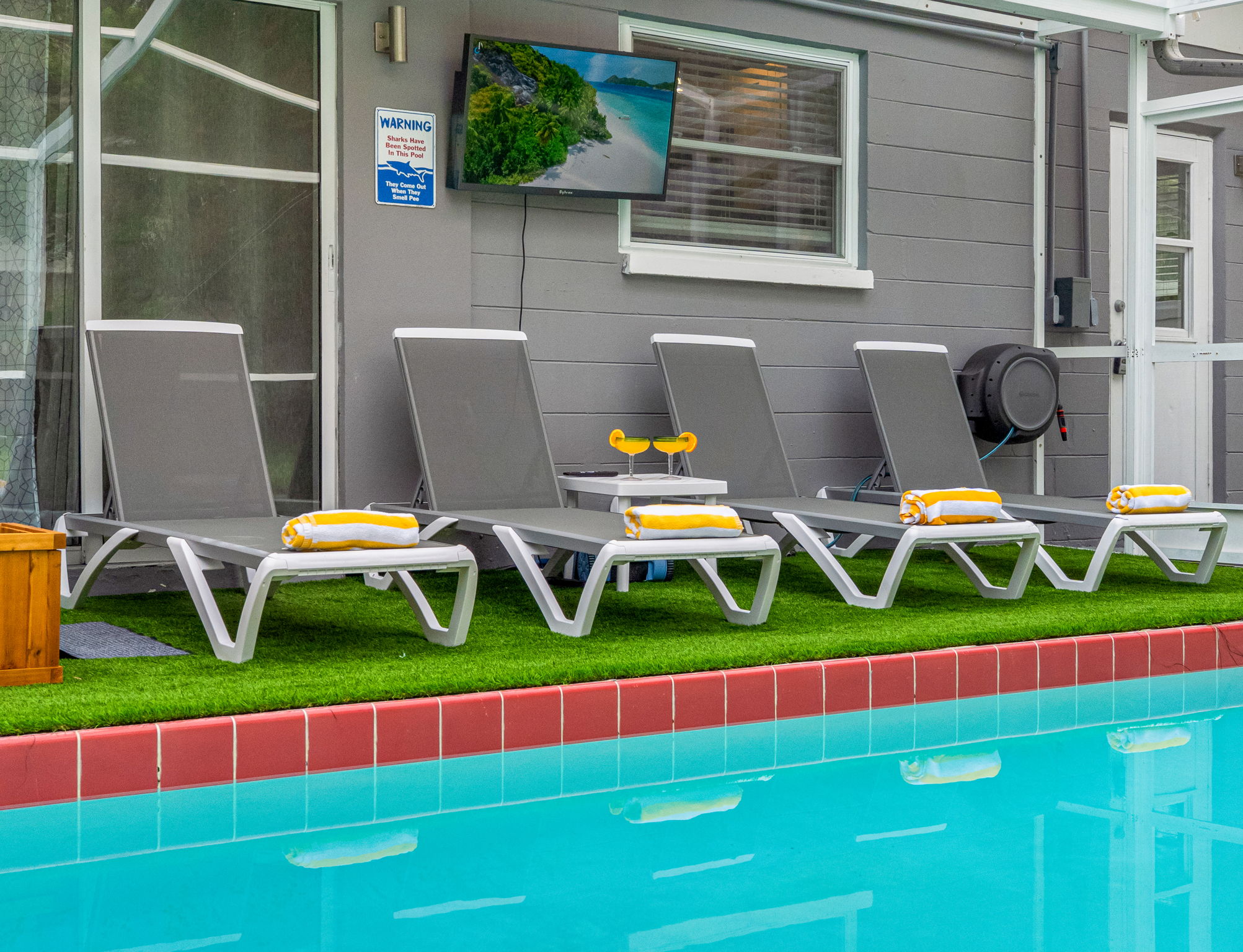 Lined with comfy loungers, fresh towels, and your favorite show playing on the outdoor TV—this is poolside living at its best.