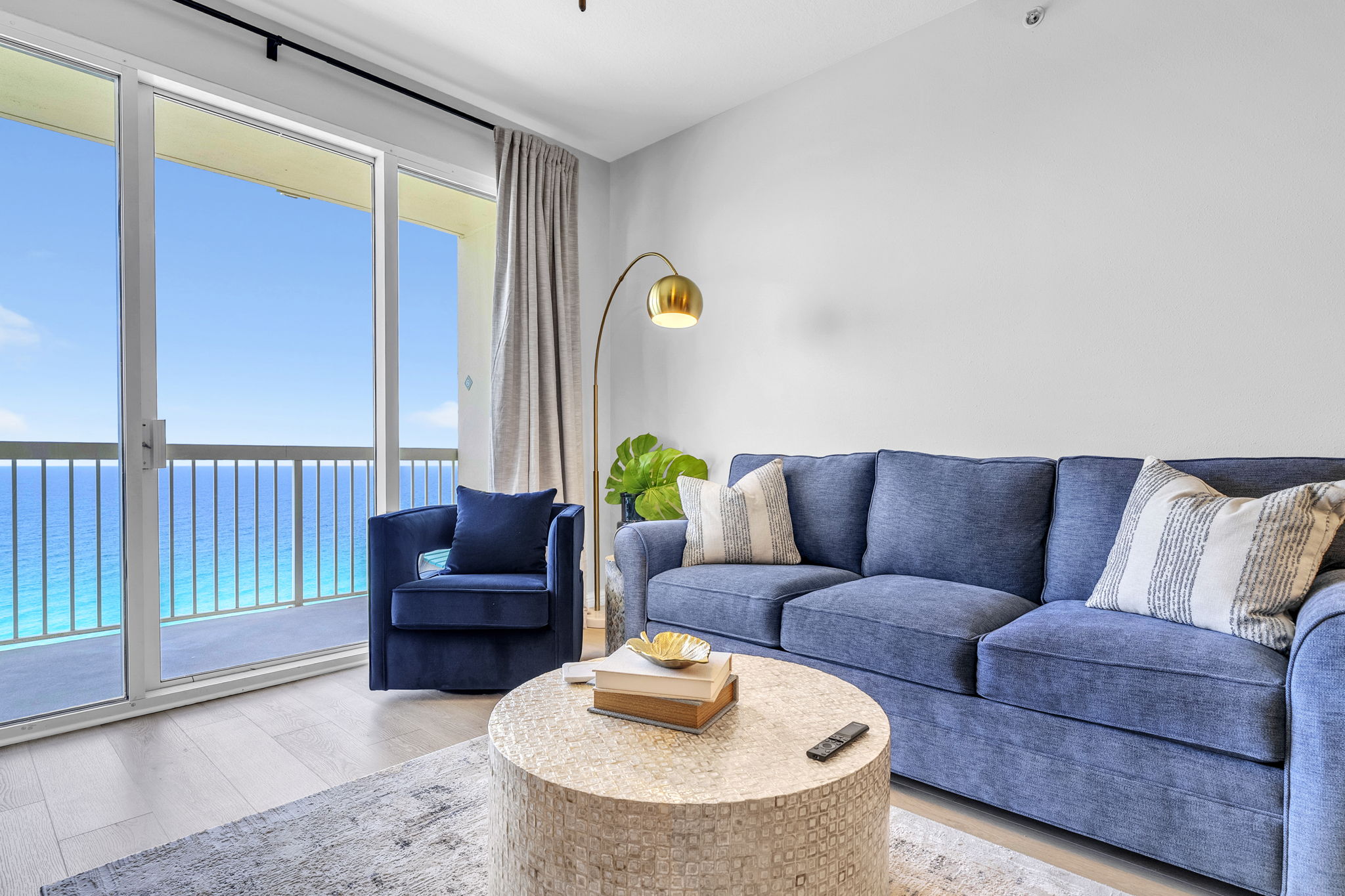Enjoy a front-row seat to the Gulf from this bright, coastal living space. Comfortable seating, natural light, and direct balcony access create the perfect spot to relax and take in the view.