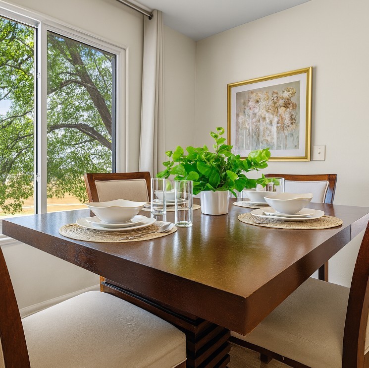 Cozy and colorful dining space with comfortable chairs and contemporary wall art.
