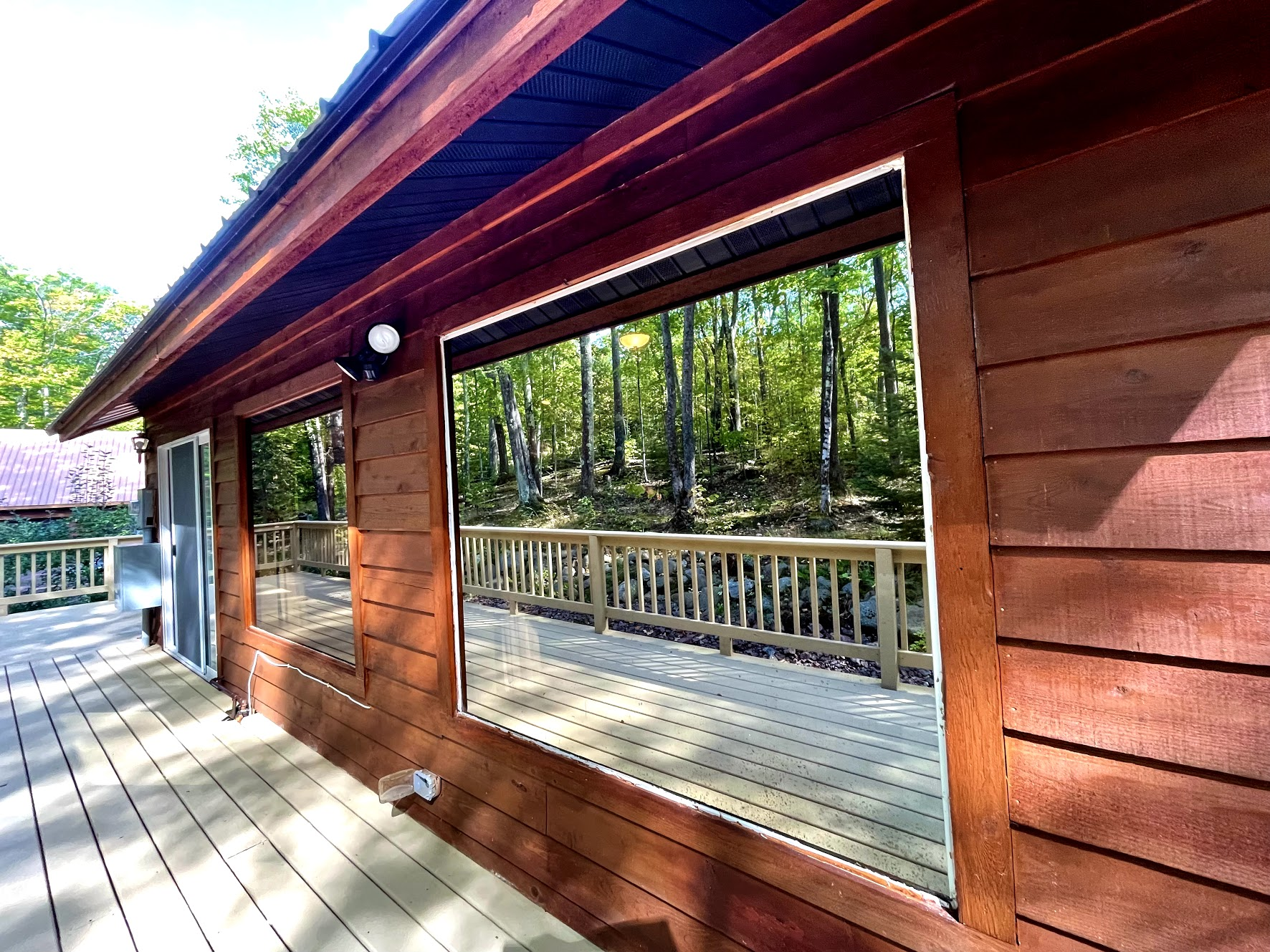 Two huge reflective mirrored panoramic windows you can see out but nature can’t see in! Summer views 
